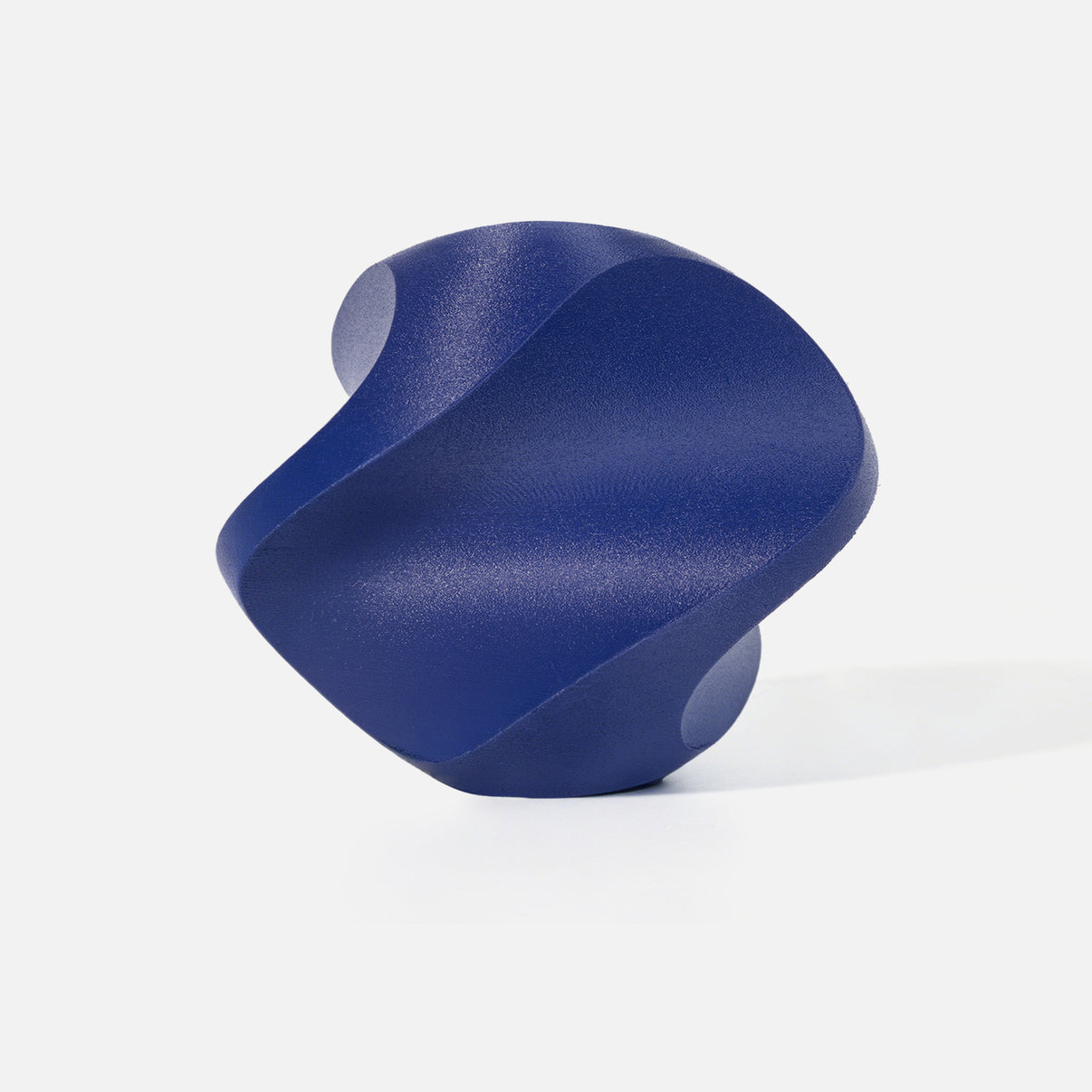 INKCLOUD PETG-CF 3D printer filament in Indigo, fine-textured carbon-fiber curved print sample on white